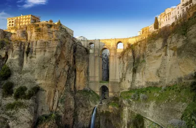 Village Ronda sitting on rocky clifftops and Puente Nuevo, a bridge in Ronda in Andalusia, Spain.